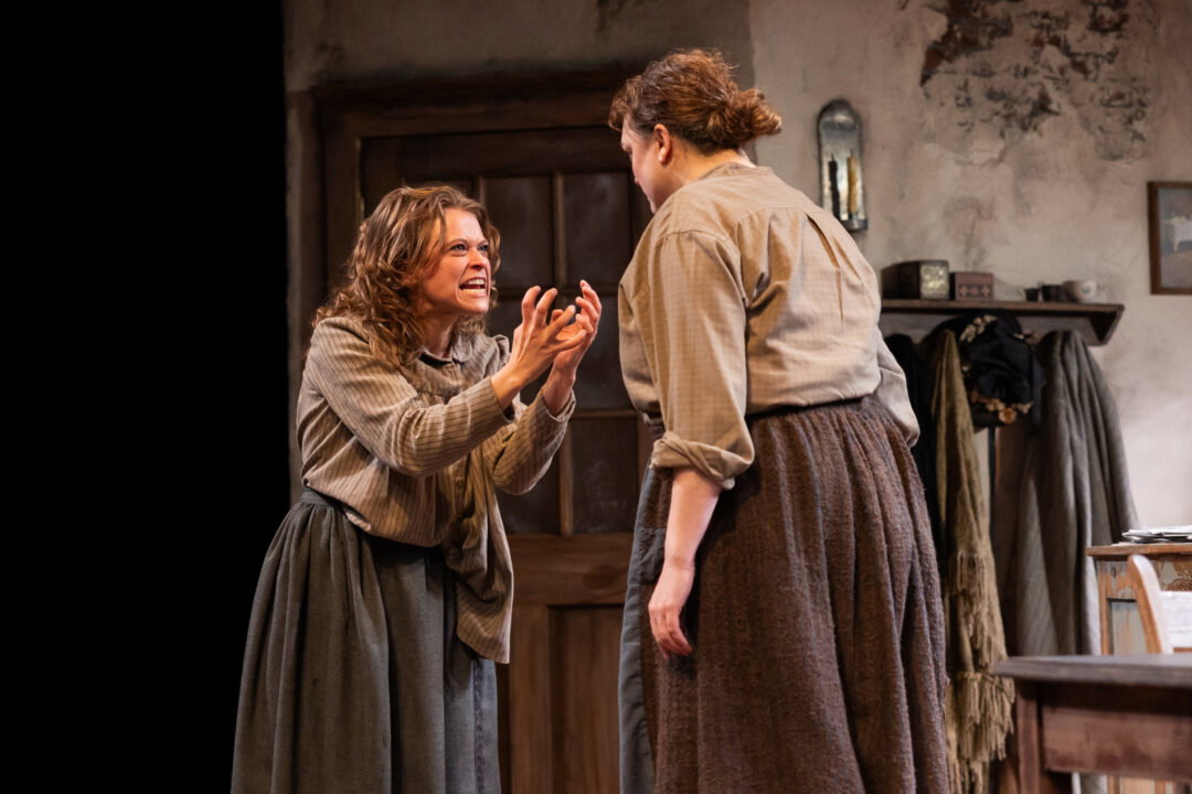 A woman in Victorian garb screams at another one.