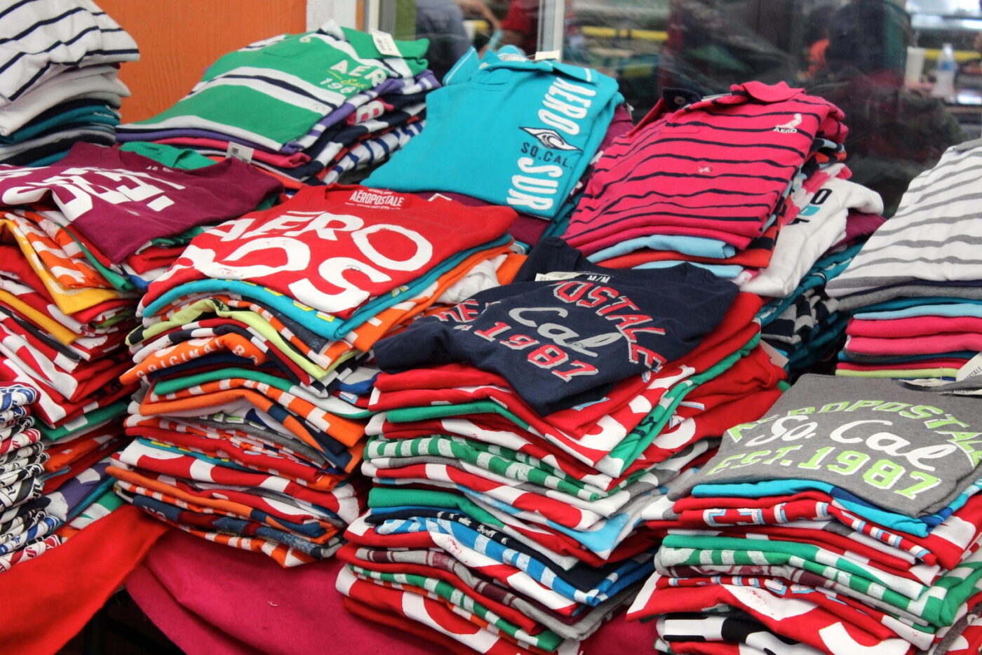 Aeropostale shirts are sold in bulk at several stands.