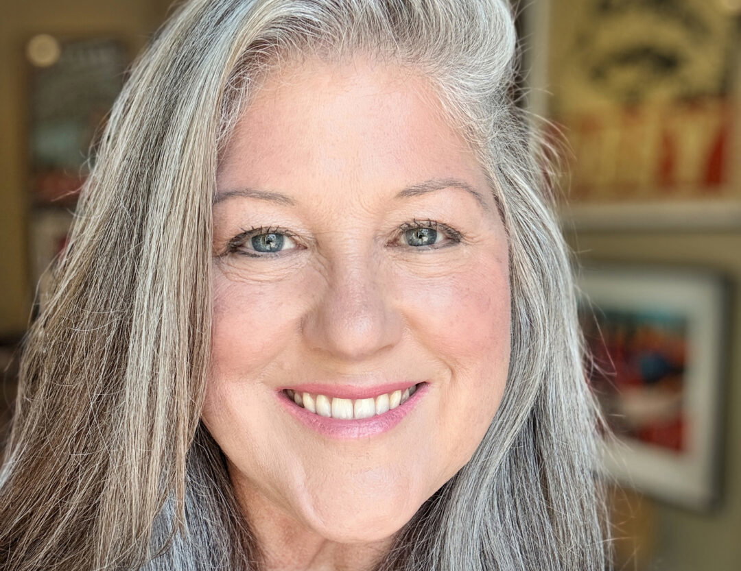 A smiling, femme-presenting woman.