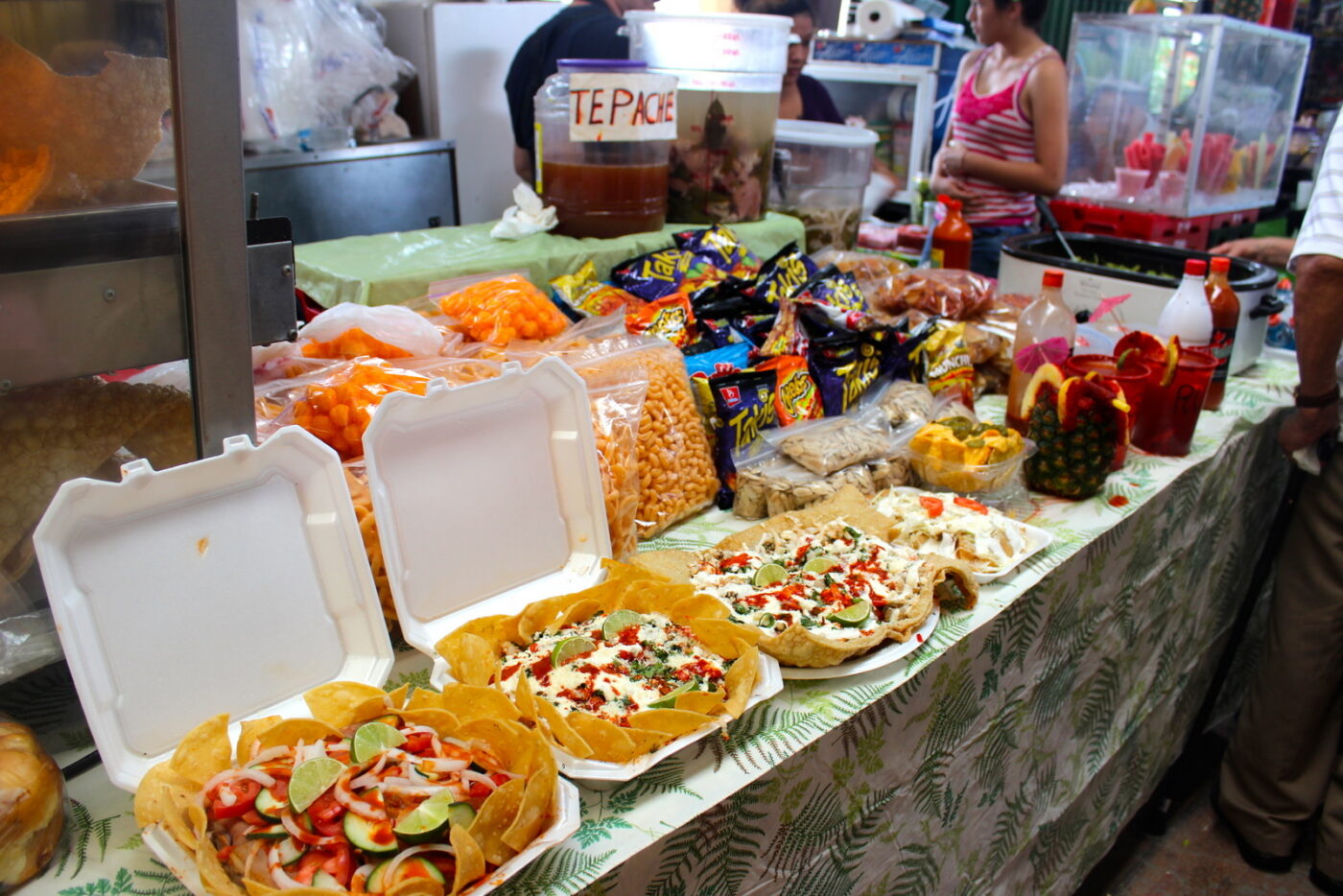 Food stands offer examples of their most popular dishes, such as the Sunny special: a giant sheet of chicharron covered with refried beans, crema, and various vegetables.