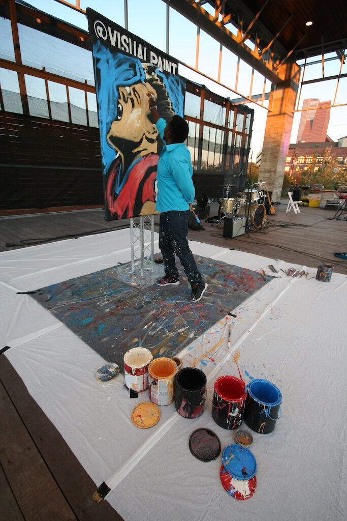 Artist Ange Hillz create a canvas onsite at Sip & Savor