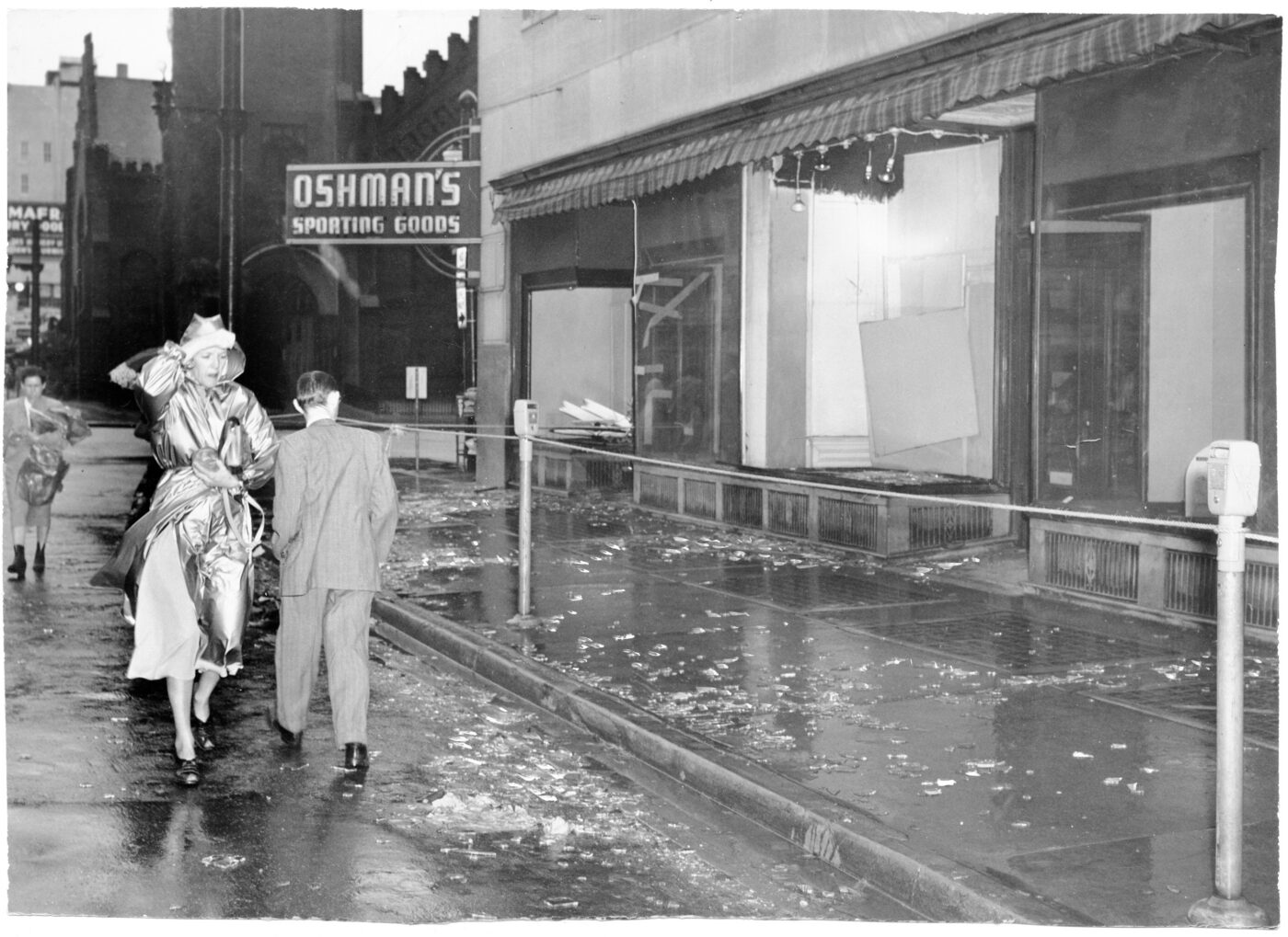 A woman passes the blown-out windows of Oshman’s downtown following a severe thunderstorm in 1949.