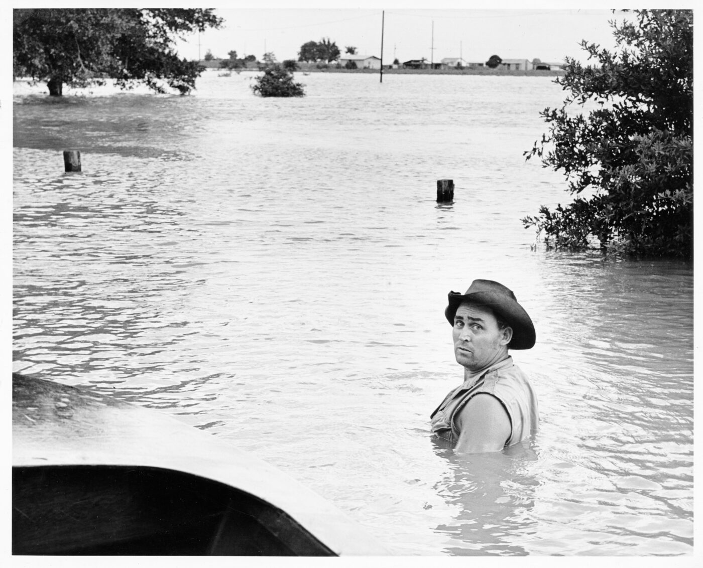 A.B. Winstead, who stands 6-foot-3, surveys the summer floods of June 1960, which left Cypress Creek, Spring Creek, Sims Bayou, White Oak Bayou and the San Jacinto River out of their banks.