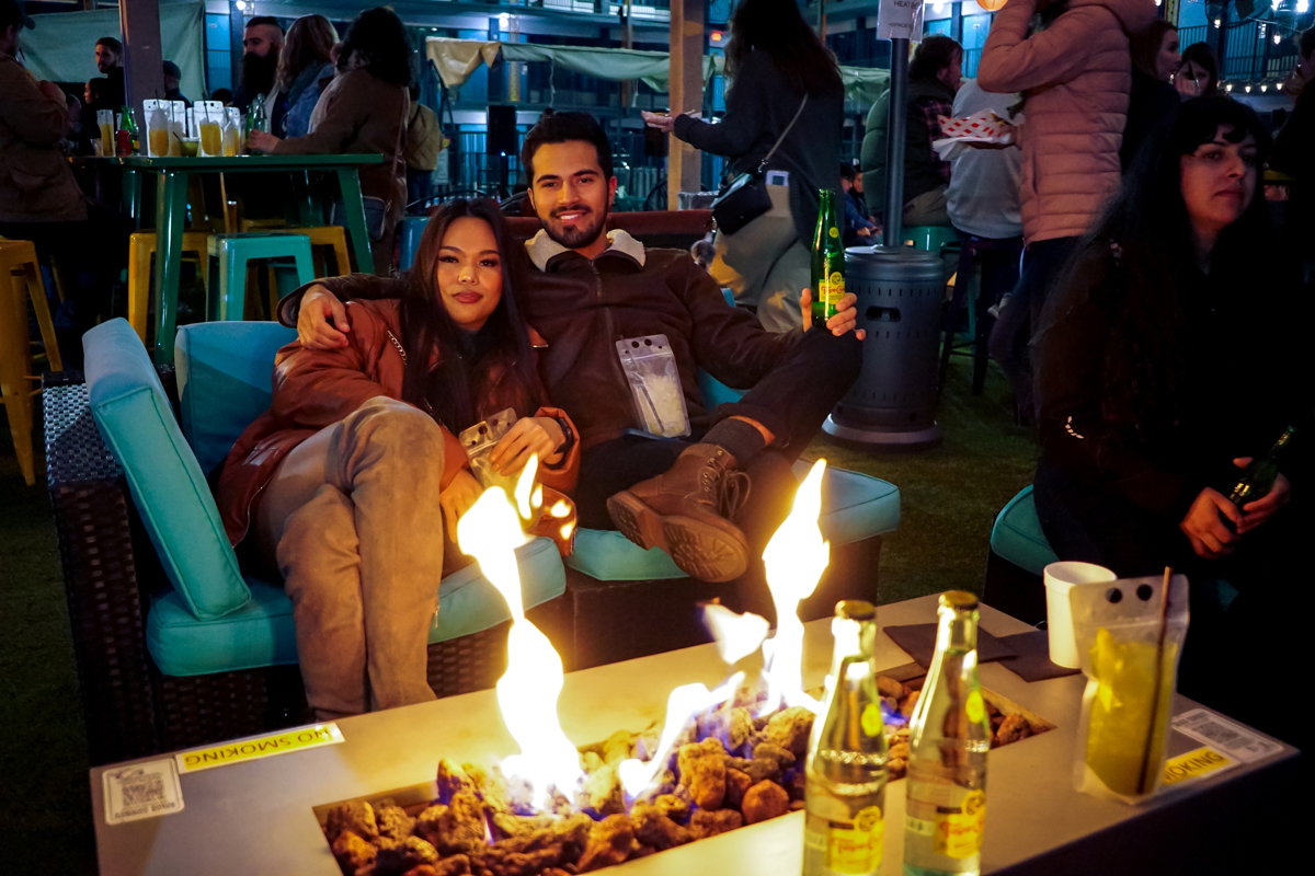 A couple gets cozy by the fire on a cool but pleasant evening in Houston.